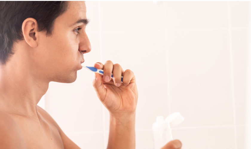 Patient brushing teeth incorrectly while learning proper oral hygiene techniques at a Charlottesville dental office
